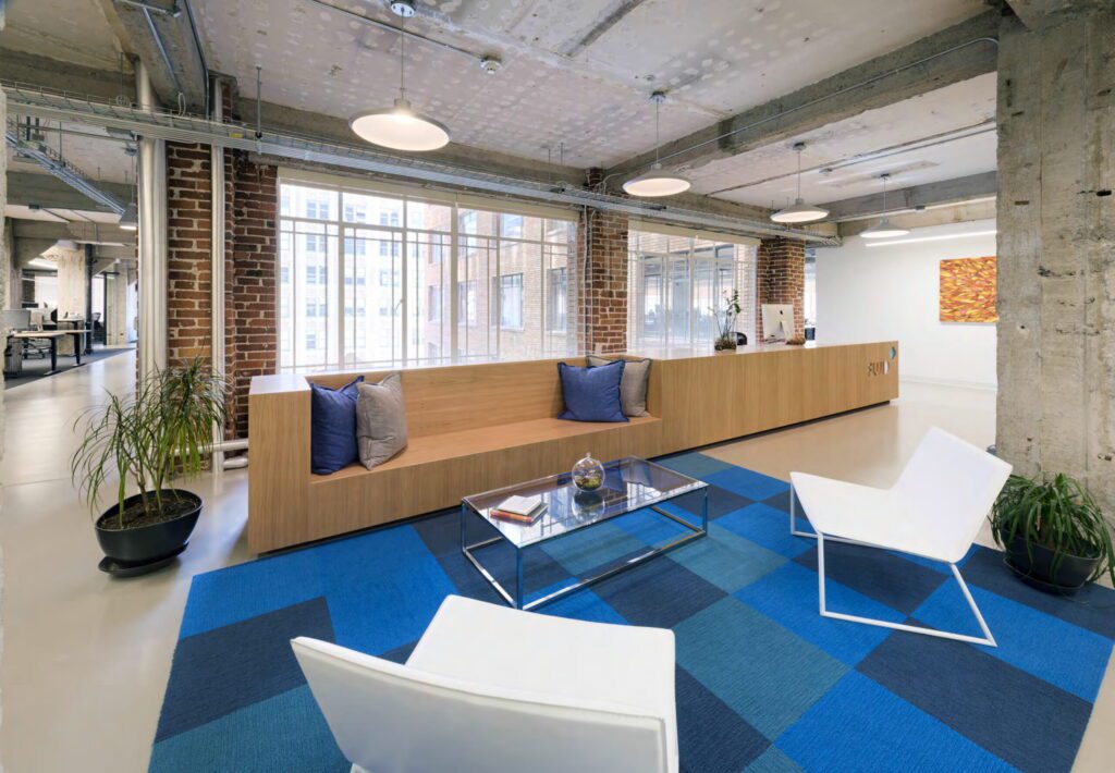 Modern office lounge with blue carpet