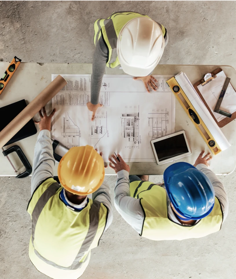 Architects reviewing building plans on table
